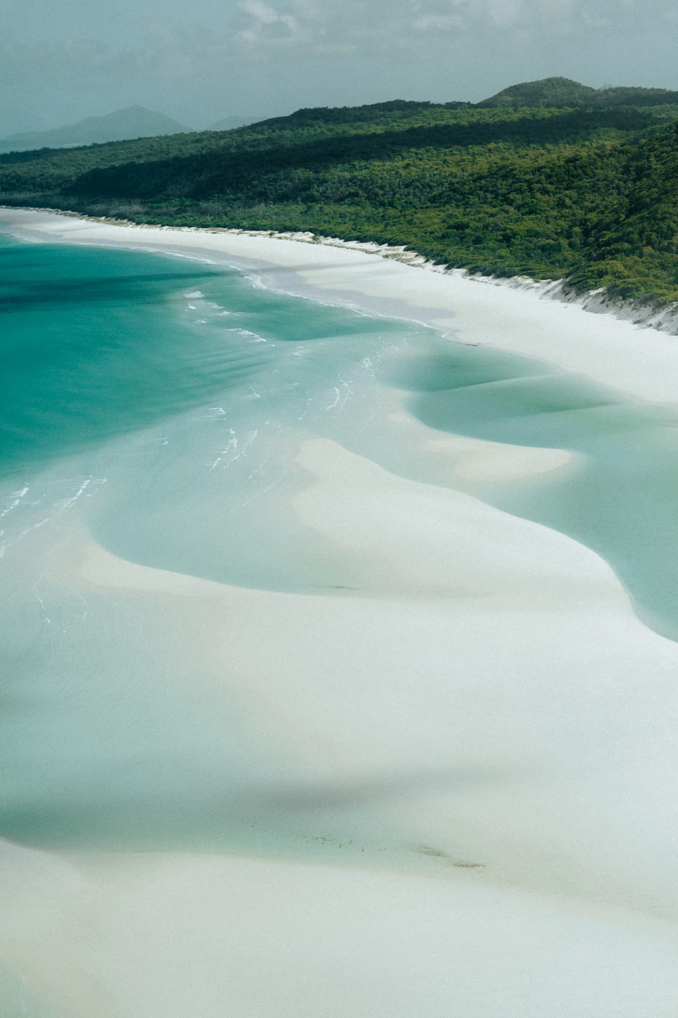 Aerial view of the couple on the swirling white sands of Whitehaven Beach