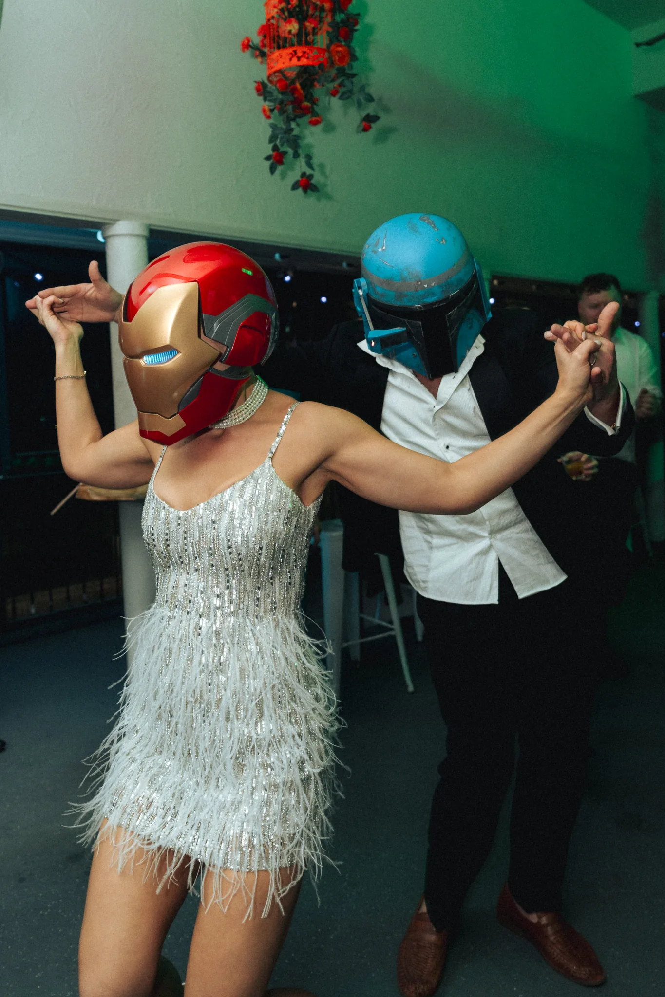 The bride celebrates on the dance floor amid balloons and confetti